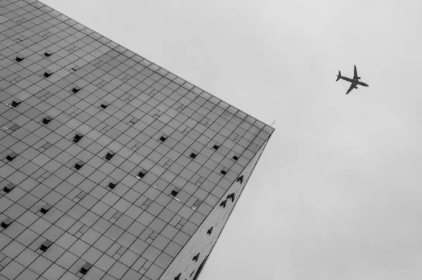 Office building and aircraft illustrating international trade
